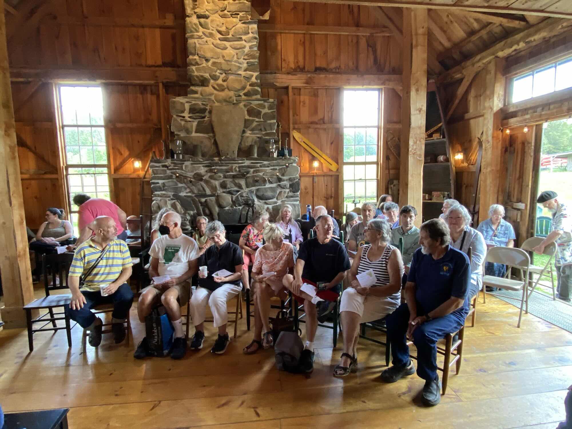 audience assembling in barn